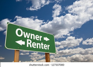 Owner, Renter Green Road Sign Over Dramatic Clouds And Sky.