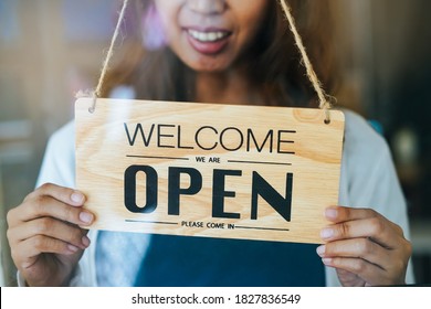 Owner retail shop turning sign board to open store after close lockdown in covid-19 situation - Shutterstock ID 1827836549