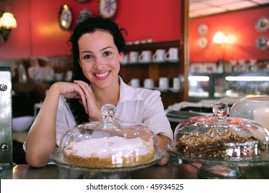 Owner Of A Small Business Store Showing Her Tasty Cakes