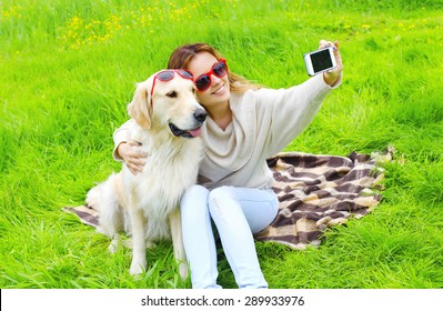 Owner woman with Golden Retriever dog taking selfie portrait on the smartphone in summer day - Powered by Shutterstock