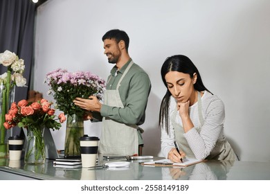 Owners of a small flower shop collaborate on beautiful floral designs with passion. - Powered by Shutterstock