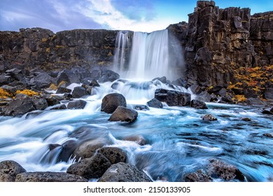 Oxarafoss, or the waterfall in the Ax River, in the Thingvellir national park, Iceland. Long exposure of the fast flowing water in Autumn. - Shutterstock ID 2150133905