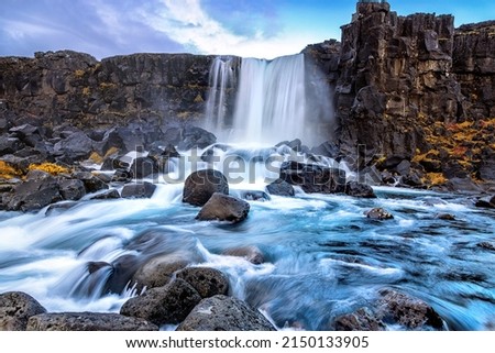 Oxarafoss, or the waterfall in the Ax River, in the Thingvellir national park, Iceland. Long exposure of the fast flowing water in Autumn.
