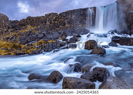 Oxarafoss, or the waterfall in the Ax River, in the Thingvellir national park, Iceland. Long exposure of the fast flowing water in Autumn.