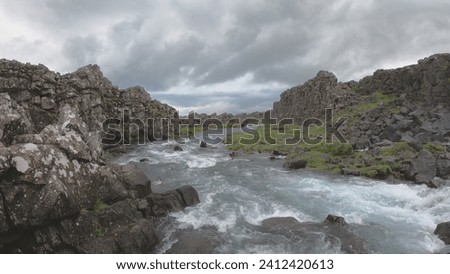 Oxararfoss is a waterfall situated within Þingvellir National Park in Southwest Iceland. The waterfall flows out the river Oxará, cascading in two drops over the cliffs of Almannagjá gorge.