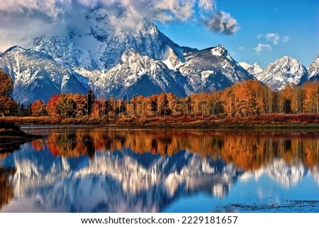 Oxbow Reflections-
With its summit shrouded in clouds, Mount Moran is reflected in the still water of the Snake River at Oxbow Bend on a cool fall morning in Grand Teton National Park, Wyoming.