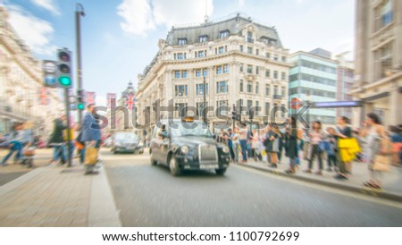 Oxford Circus, London- anonymous motion blurred shoppers on sunny day