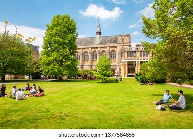 OXFORD, ENGLAND - JUNE 19, 2013: Students relaxing on the grass outside Balliol College of Oxford University