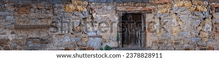 Oxford Old Stone Wall with door, rough sandy texture old medieval stone wall, atmosphere of antiquity and university style Background for design, copy space