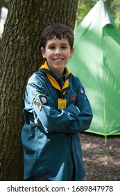 Oxford, Oxfordshire, UK 05 05 2019 A Portrait Of Boy Scout Camping In England With A Green Tent Behind Him