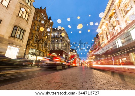 Oxford street in London with Christmas lights and blurred traffic. It is one of the busiest street of the capital city of England, and during Christmas time it becomes magic and fairy.