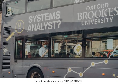 Oxford, UK - August 04, 2020: View From The Street Of People In Protective Face Masks On A Bus In Oxford. Masks Are Mandatory On Public Transport In UK Due To Coronavirus Pandemic.