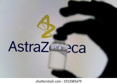 OXFORD, UK - February 2020: Covid vaccine vial in front of the Astrazeneca logo