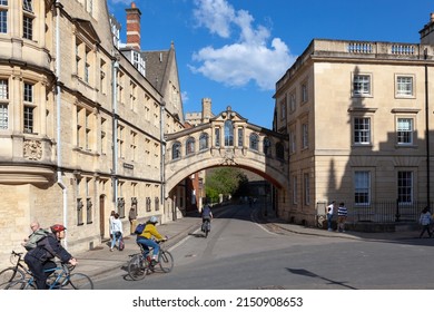 Oxford, United Kingdom - April 15, 2022: Cyclists about to go under the Bridge of Sighs; a skyway connecting two parts of Hertford College.