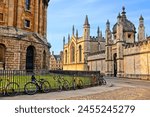 Oxford University at dusk, England, UK. Radcliffe Camera and All Souls College with bicycles on cobblestone streets. 