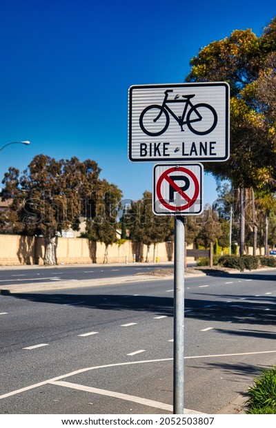 Oxnard,\
United States - February 20 : a road sign is indicating a bike lane\
on the road and that parking is not\
allowed