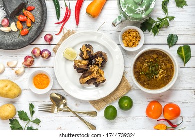 Oxtail Soup And Fried Oxtail Are Served On The Table Side By Side With The Basic Spices.