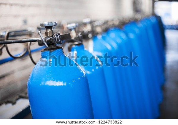 Oxygen cylinder with\
compressed gas. Blue Oxygen tanks for industry. Liquefied oxygen\
production. Factory