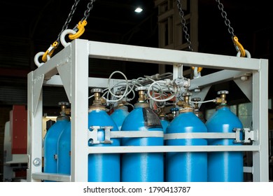 Oxygen Cylinders In A Cassette Suspended From The Hooks Of A Crane In The Workshop Of The Plant.