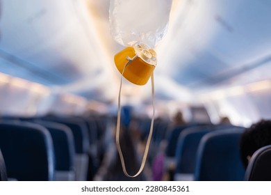 oxygen mask drop from the ceiling compartment on airplane	 - Shutterstock ID 2280845361