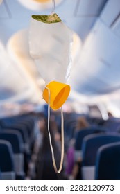 oxygen mask drop from the ceiling compartment on airplane	 - Shutterstock ID 2282120973