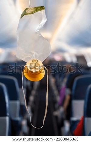 oxygen mask drop from the ceiling compartment on airplane	
