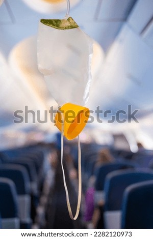 oxygen mask drop from the ceiling compartment on airplane	
