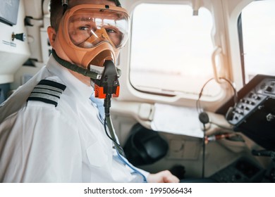 In Oxygen Mask. Pilot On The Work In The Passenger Airplane. Preparing For Takeoff.