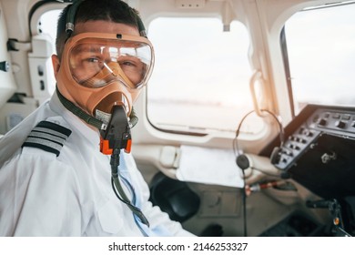 In Oxygen Mask. Pilot On The Work In The Passenger Airplane. Preparing For Takeoff.