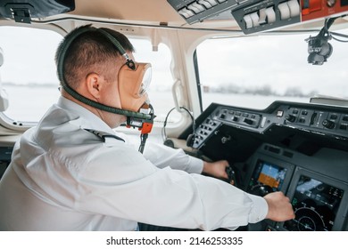 In Oxygen Mask. Pilot On The Work In The Passenger Airplane. Preparing For Takeoff.