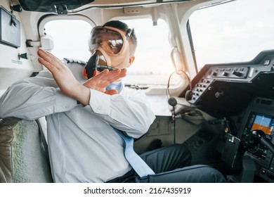 In Oxygen Mask. Pilot On The Work In The Passenger Airplane. Preparing For Takeoff.