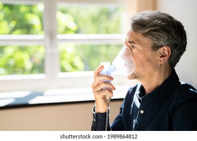 Oxygen Mask For Pulmonary Disease And Fibrosis. Man Inhaling