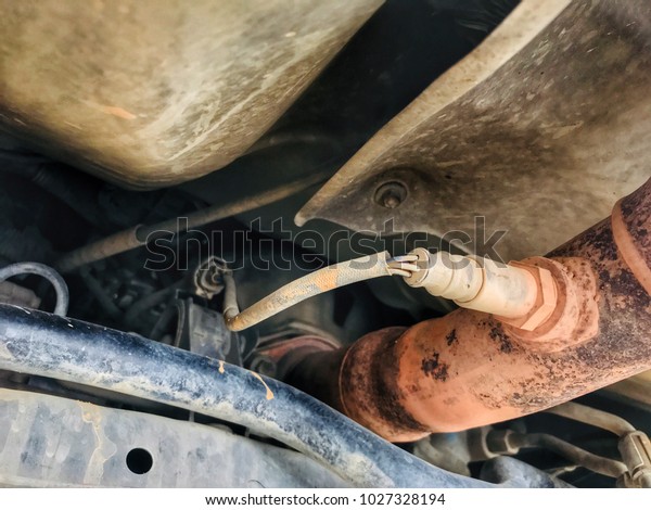 Oxygen sensor, Oxygen sensor in car exhaust. Under\
the car.