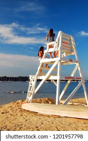 Oyster Bay, NY, USA June 30 Two teenage girls chat while looking at the view of Long Island Sound from Roosevelt Beach in Oyster Bay