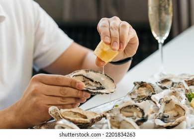 oyster. Man eating shellfish. Seafood and Mediterranean cuisine with mussels in shell. oyster in luxury restaurant.