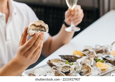 Oyster. Man Eating Shellfish. Seafood And Mediterranean Cuisine With Mussels In Shell. Oyster In Luxury Restaurant.