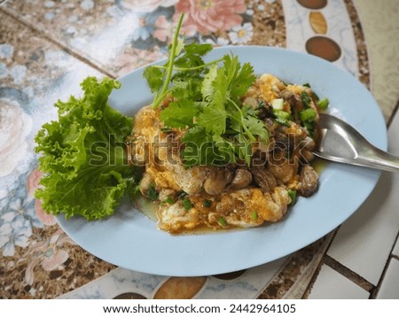 Oyster omelet on blue dish in selective focus