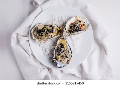 Oyster Rockefeller And Sake-poached Oyster, Cooked In Hijki Butter And Black Seaweed.