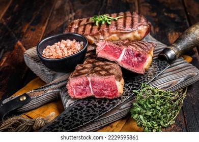 Oyster Top Blade beef meat steak grilled on summer BBQ. Wooden background. Top View.