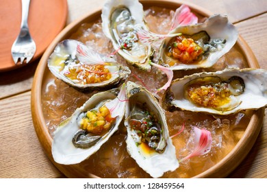 oysters with Asian sauces in ice on the plateau