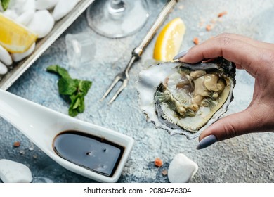 Oysters On The Half Shell. Fresh Oysters Served With Cocktail Sauce And Fresh Lemons. Oyster Dinner In Restaurant.