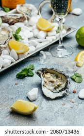 Oysters On The Half Shell. Fresh Oysters Served With Cocktail Sauce And Fresh Lemons. Oyster Dinner In Restaurant.