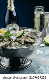 Oysters with wine, lemon, and ice. oysters dish. Oyster dinner with champagne in restaurant. banner, menu, recipe place for text, top view.