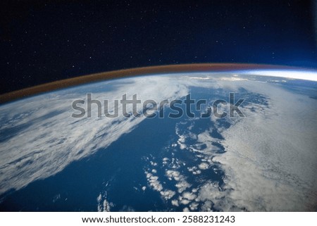 The ozone layer of the earth. Earth from space with clouds and blue ocean. The blue planet is surrounded by a dark sky. Blue planet in space. Elements of this image furnished by NASA