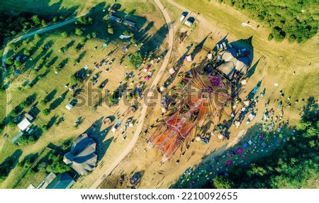 Ozora: a hungarian goa psy trance summer festival's main stage with colorful design by an aerial upsidedown shot