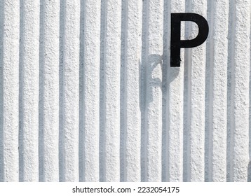 P text on white wall background, P stamp on white wall, consonant P on white wall. - Shutterstock ID 2232054175