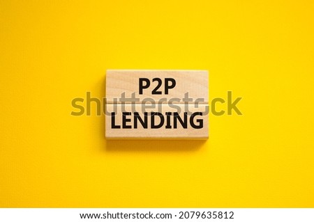 P2P peer to peer lending symbol. Concept words P2P lending on wooden blocks on a beautiful yellow background. Business and P2P peer to peer lending concept. Copy space.