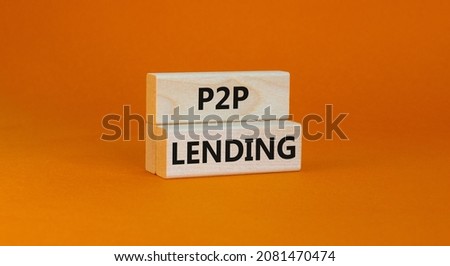 P2P peer to peer lending symbol. Concept words P2P lending on wooden blocks on a beautiful orange background. Business and P2P peer to peer lending concept. Copy space.