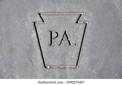 PA etched into a stone. Pennsylvania the Keystone State.