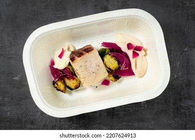 Pacific Amberjack Fillet With Vegetables And Sauce. In A Plastic Takeout Container